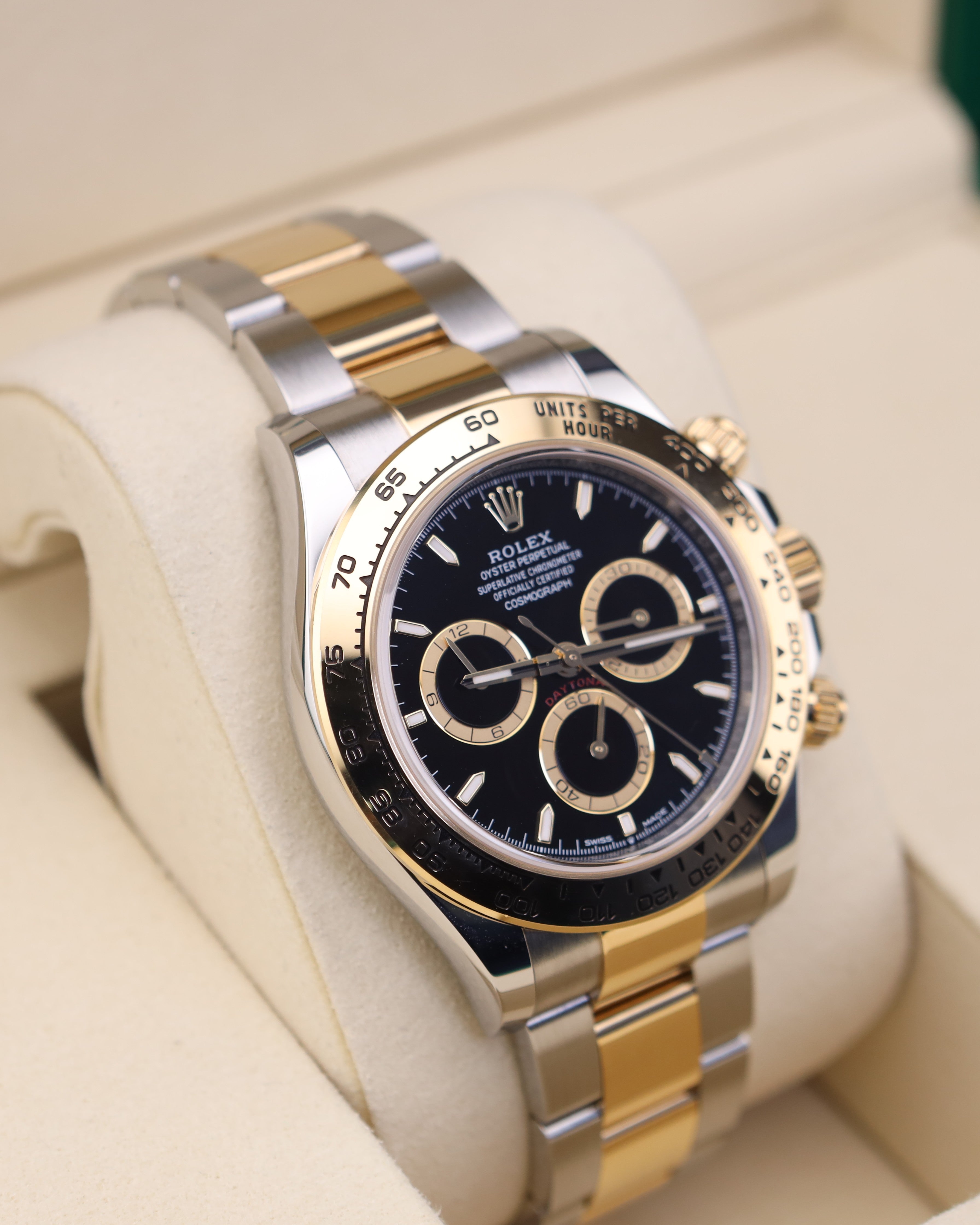 Luxury two-tone watch with black dial on a white background